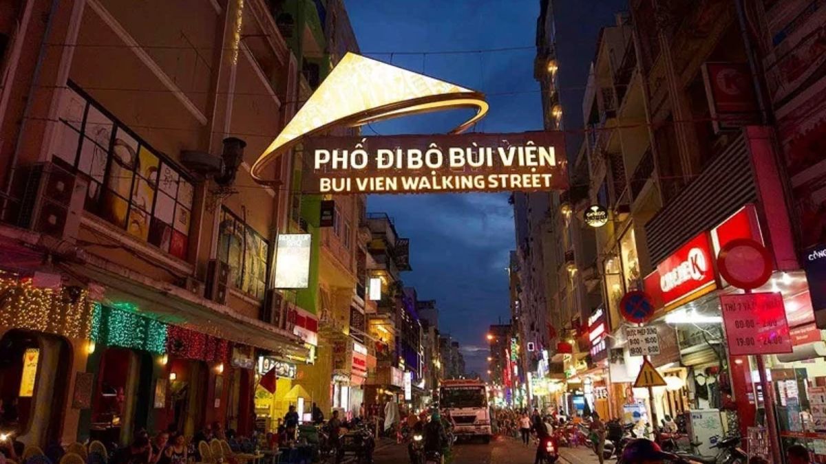 Crowds of locals and tourists exploring Bui Vien Walking Street in Ho Chi Minh City, surrounded by vibrant bars, restaurants, live music venues, and colorful neon lights.