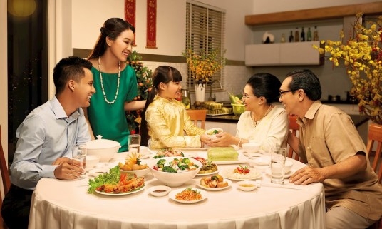 Vietnamese family enjoying a traditional Tet New Year meal together during Lunar New Year celebrations
