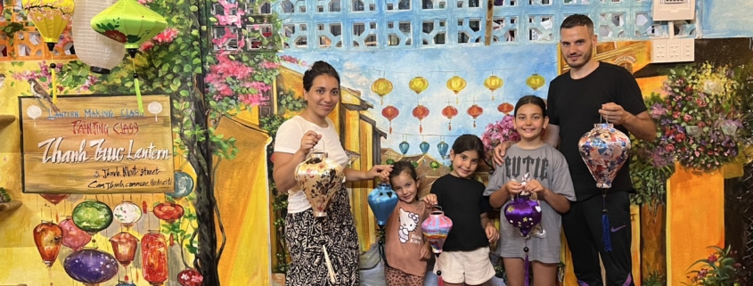 Family joining a lantern-making workshop in Hoi An, Vietnam