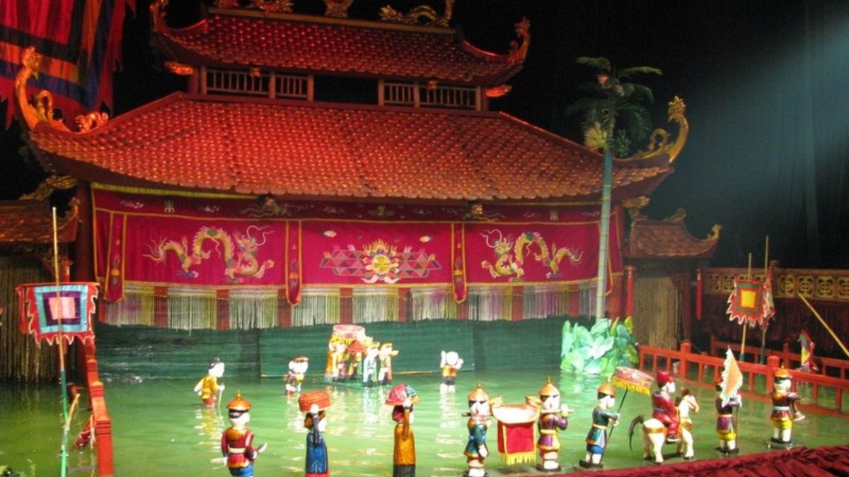 Children and families watch a traditional Vietnamese water puppet performance, enjoying colorful puppets and live folk music at a water puppet theater in Vietnam.