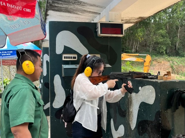 International tourist firing an AK47 rifle at the Cu Chi Tunnels shooting range