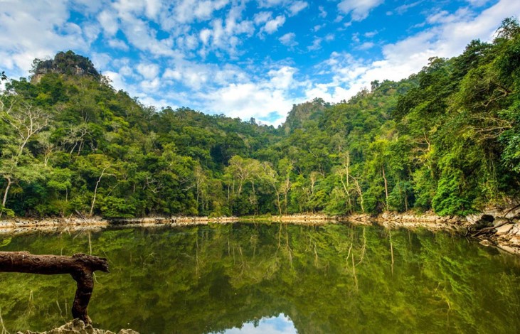 Ao Tien Lake surrounded by green mountains and peaceful nature in Ba Be National Park, Vietnam
