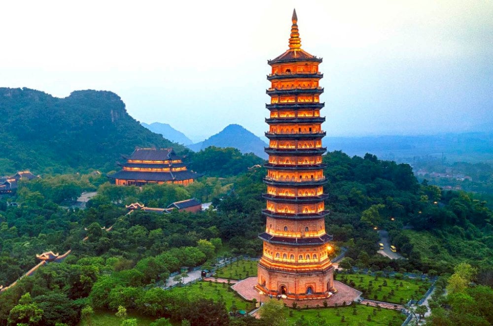 Bai Dinh Pagoda illuminated at night with glowing lights and peaceful temple architecture in Ninh Binh, Vietnam.