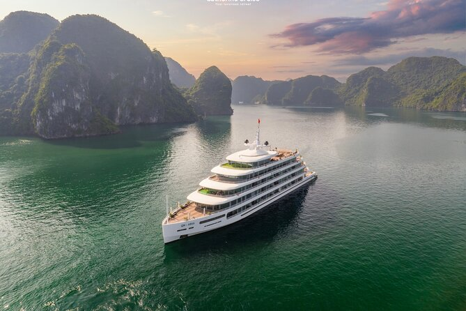 Luxury cruise sailing through the emerald waters and limestone islands of Lan Ha Bay, Vietnam.