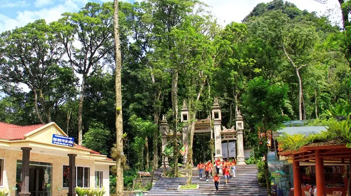 Temple entrance surrounded by lush tropical forest in Ba Vi National Park, Vietnam
