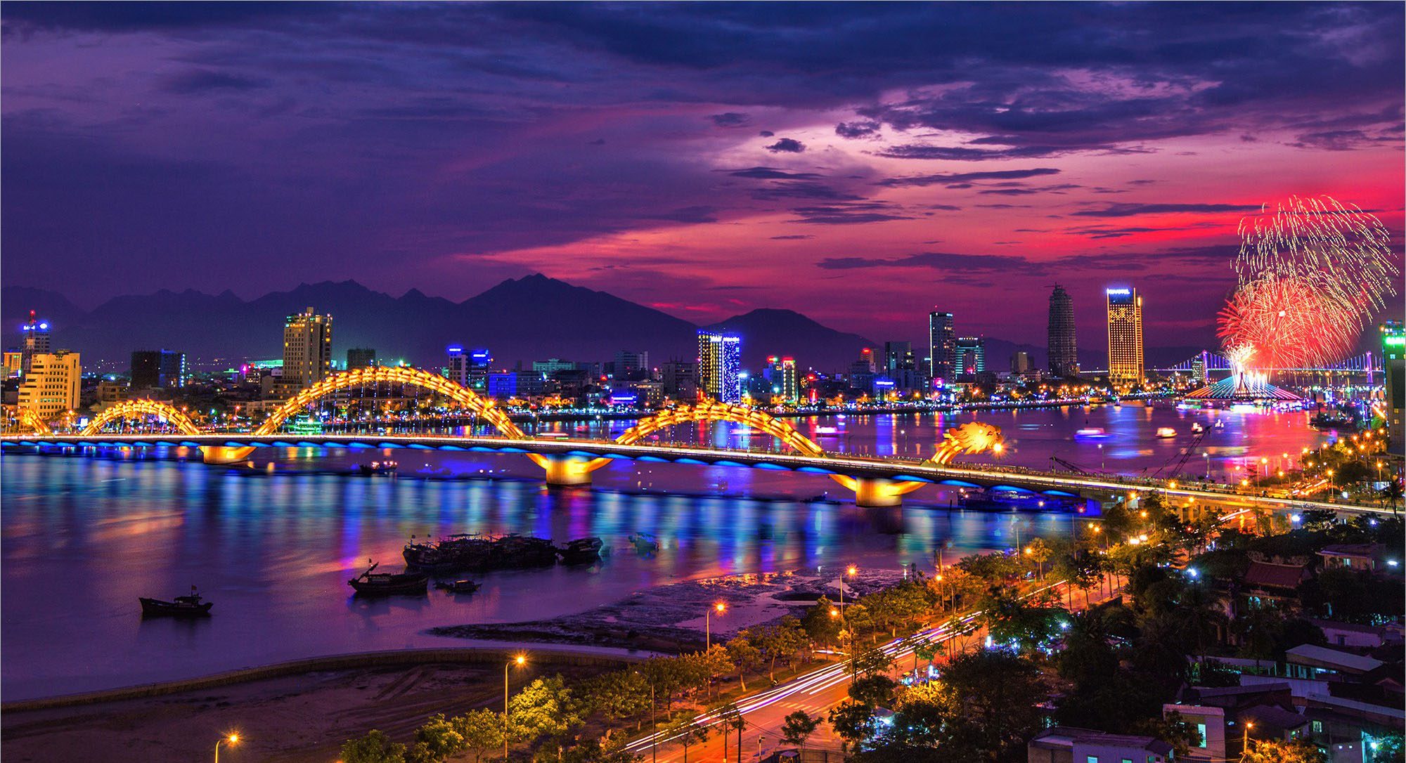 Dragon Bridge illuminated at night over Han River in Da Nang Vietnam