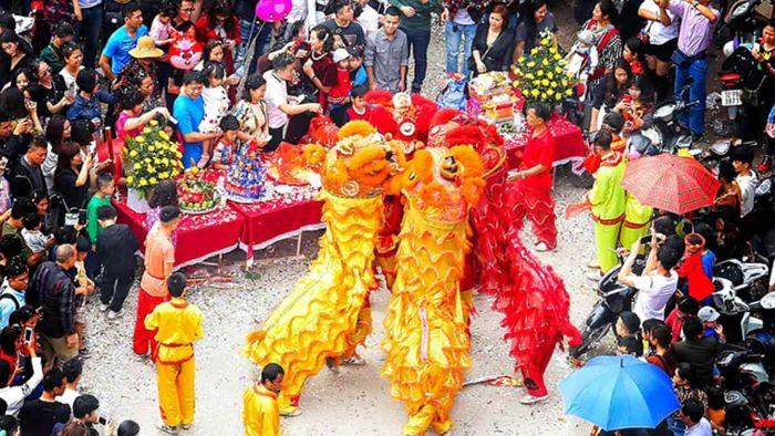 raditional lion dance performance during a colorful festival in Lang Son surrounded by crowds of local people and visitors.