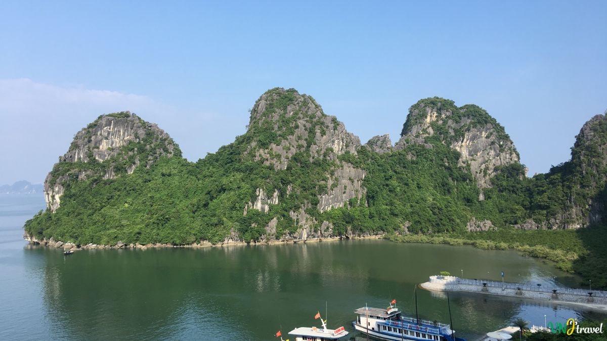 Panoramic view of Ha Long Bay featuring emerald waters, limestone karsts, traditional cruise boats, and breathtaking natural scenery in northern Vietnam.