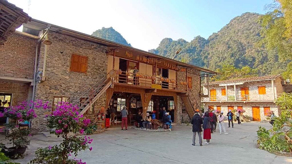 Traditional stone houses in Khuoi Ky Village surrounded by limestone mountains in Cao Bang, Vietnam.