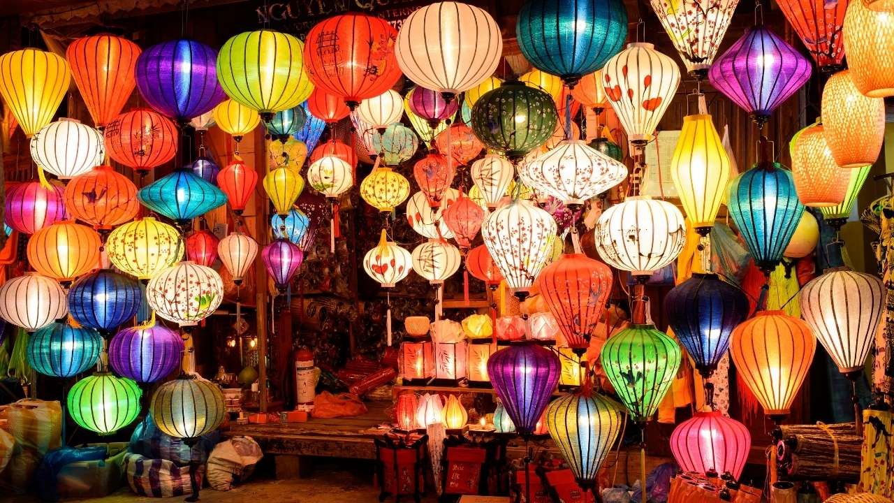 Colorful lanterns hanging in a lantern shop in Hoi An Ancient Town, creating a vibrant and glowing nighttime atmosphere.