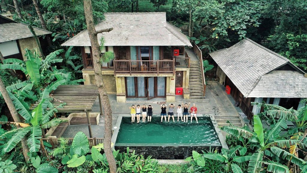 Luxury eco-resort villas surrounded by lush tropical forest and a private swimming pool in Ba Vi, Vietnam.