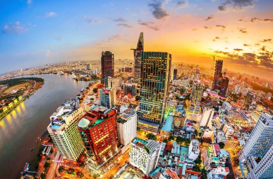Panoramic aerial view of Ho Chi Minh City skyline at sunset with Saigon River and modern skyscrapers in Vietnam