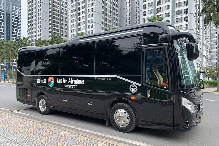 Shuttle bus for Ha Long Bay tours parked on a modern city street in Vietnam