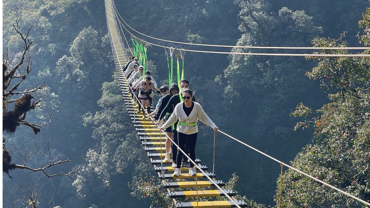 Hanoi to Sapa Tour Doc Moc Bridge in Sapa, northern Vietnam, surrounded by lush mountain scenery and peaceful forests.