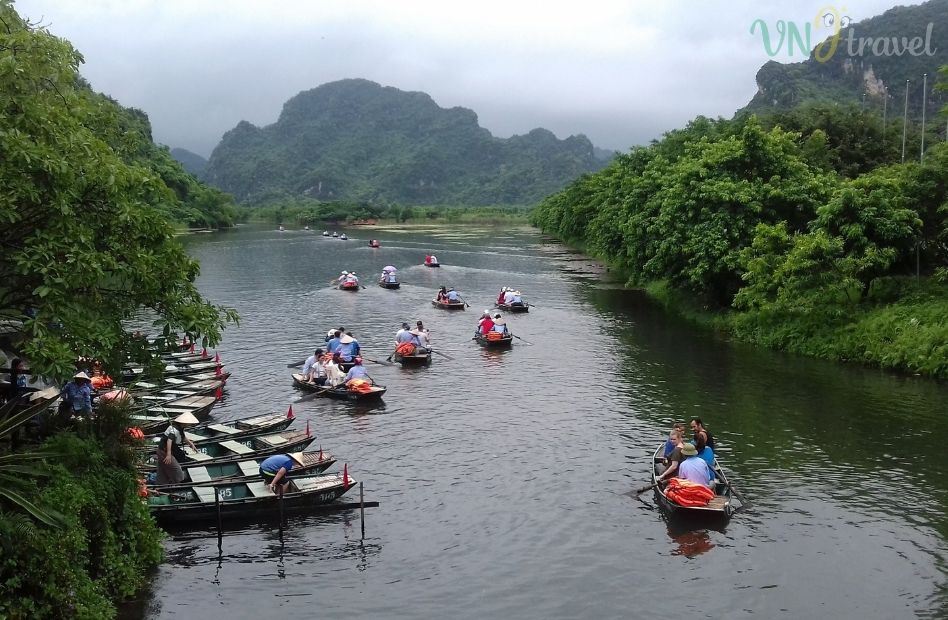 rang An boat station with tourists taking rowing boats through the scenic river