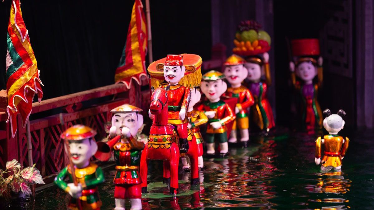 Traditional Vietnamese water puppet show featuring colorful puppets performing on a water stage in Hanoi.