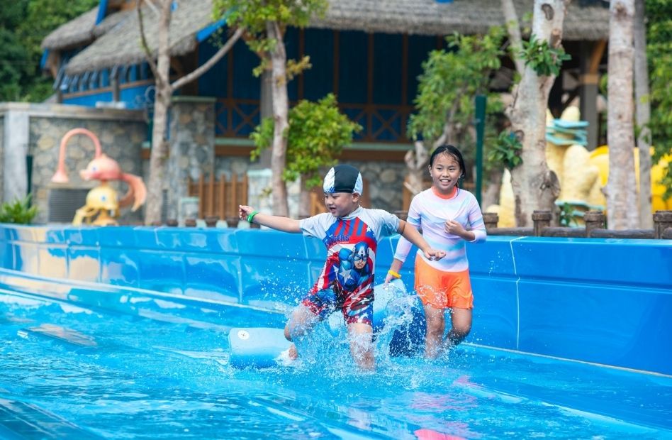 Children playing in the water playground at VinWonders Phu Quoc, enjoying a fun-filled day at Vietnam's largest theme park.