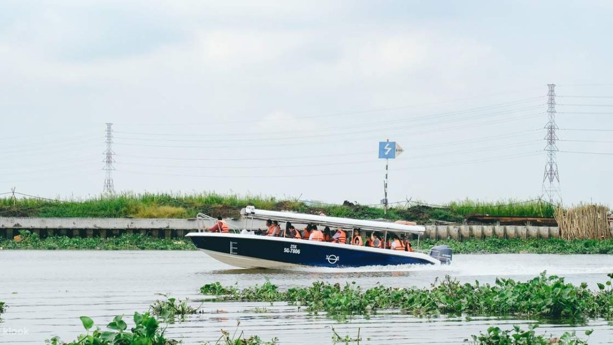 Tourists travel by eco speedboat along the Saigon River on a Cu Chi Tunnels Eco Boat Tour from Ho Chi Minh City.